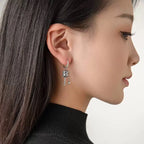 Hængende øreringe med buddhistisk bønnehjul