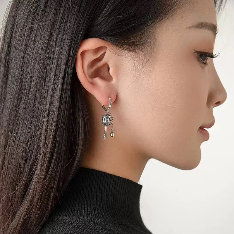 Hængende øreringe med buddhistisk bønnehjul