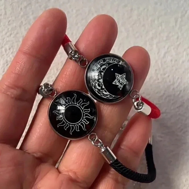 Armbånd med månesigd og lysende rød og svart sol