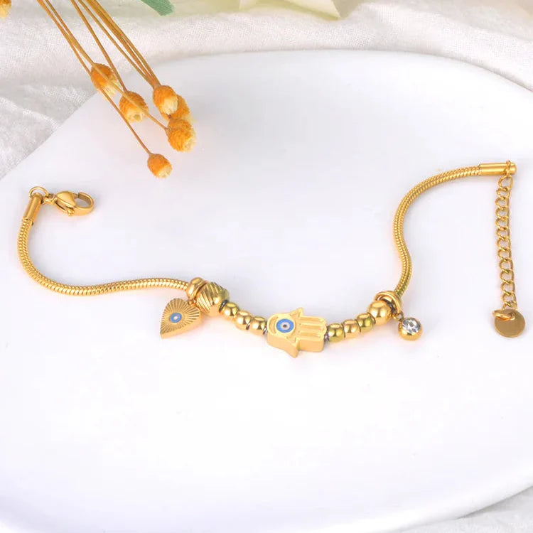 Beskyttelsesarmbånd med Fatmas hånd og blått øye gull