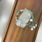 Armbånd i tau med perler og lotusblomst