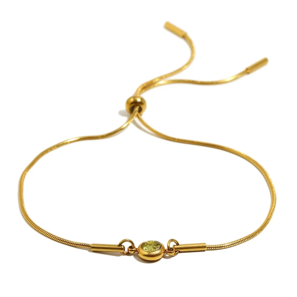Armband i öppen modell med färgad månadssten