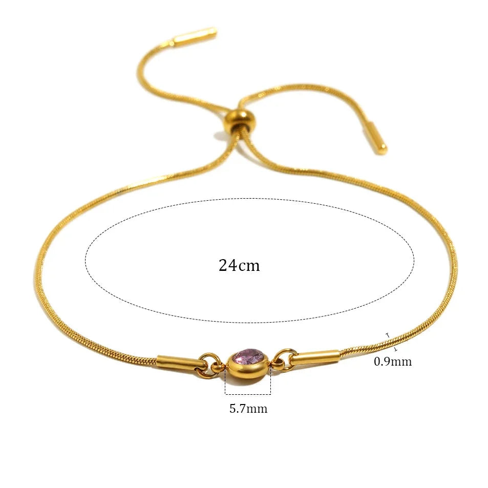 Armband i öppen modell med färgad månadssten