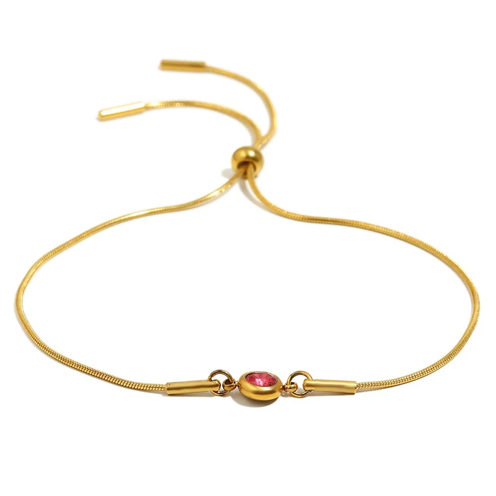 Armband i öppen modell med färgad månadssten