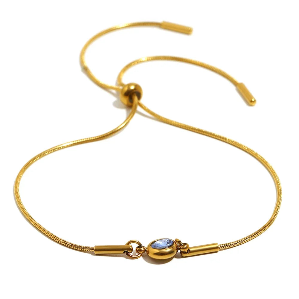 Armband i öppen modell med färgad månadssten