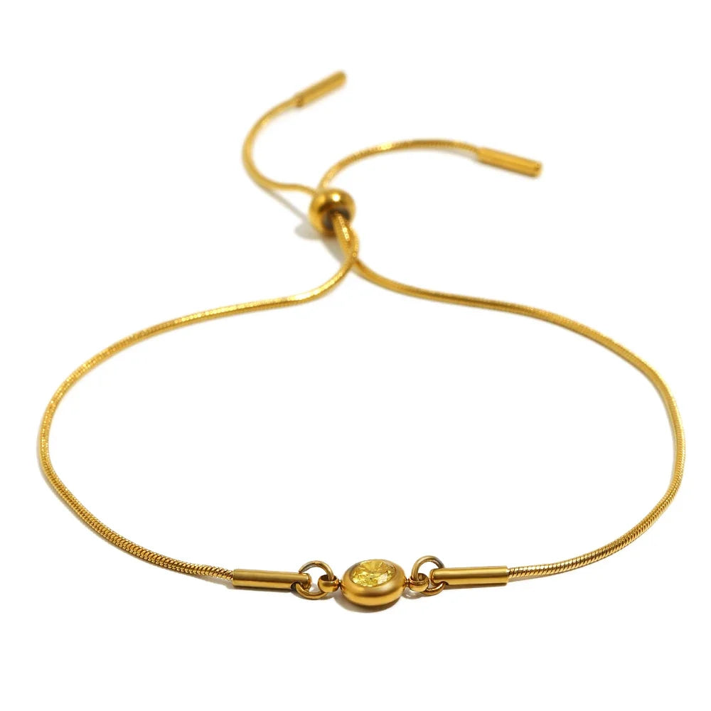 Armband i öppen modell med färgad månadssten