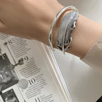 Fjäderarmband i silverfärg för dam