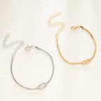 Armbånd for par med sammenflettede knuter i gull og sølv (sett med 2 armbånd)