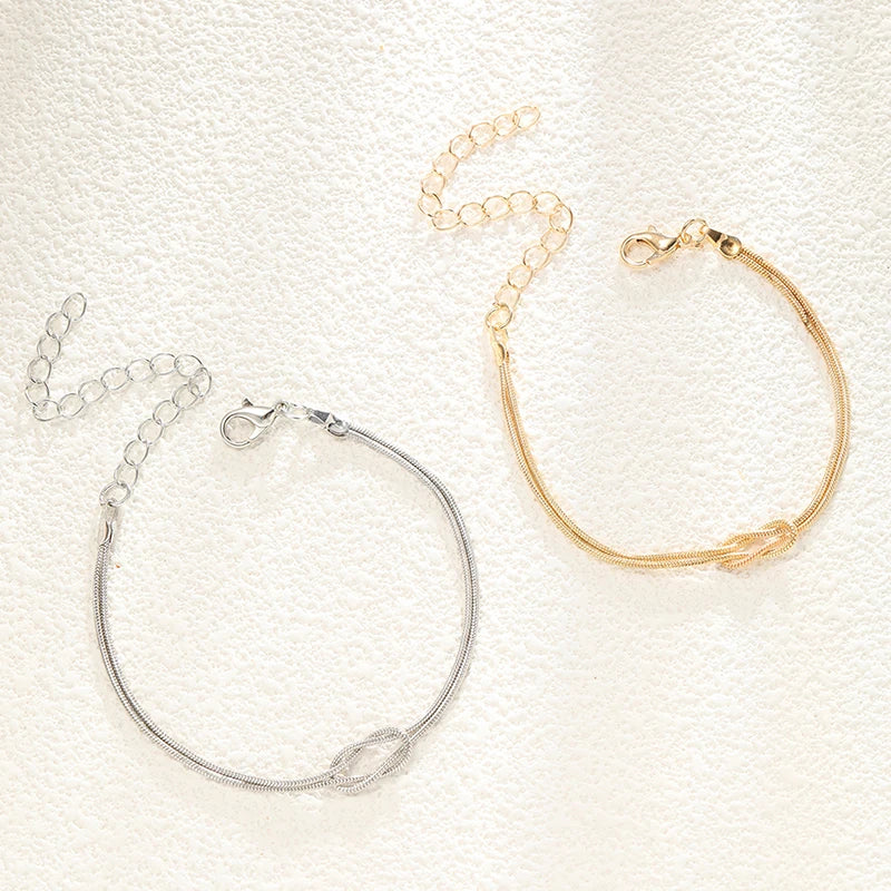 Armbånd for par med sammenflettede knuter i gull og sølv (sett med 2 armbånd)