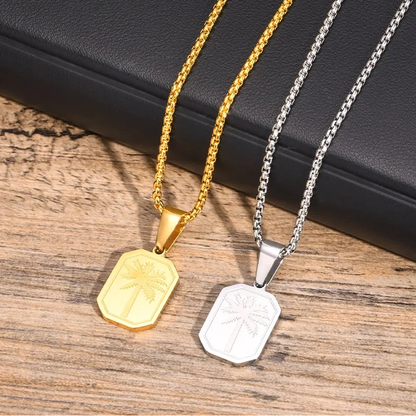 Halsband med geometriskt palmhängsmycke i guldton