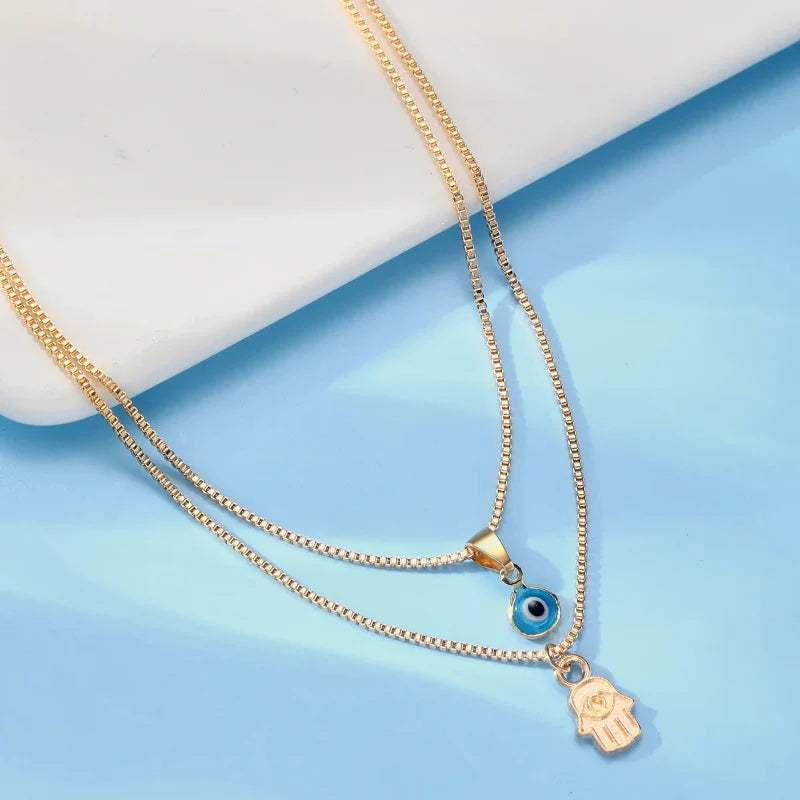 Collier Double avec Pendentif Oeil Bleu Turc et Main de Fatma or