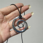 Långt halsband med silverfärgat spiralformat hängsmycke