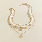 Multirang halskæde med vedhæng af muslinger og søstjerner