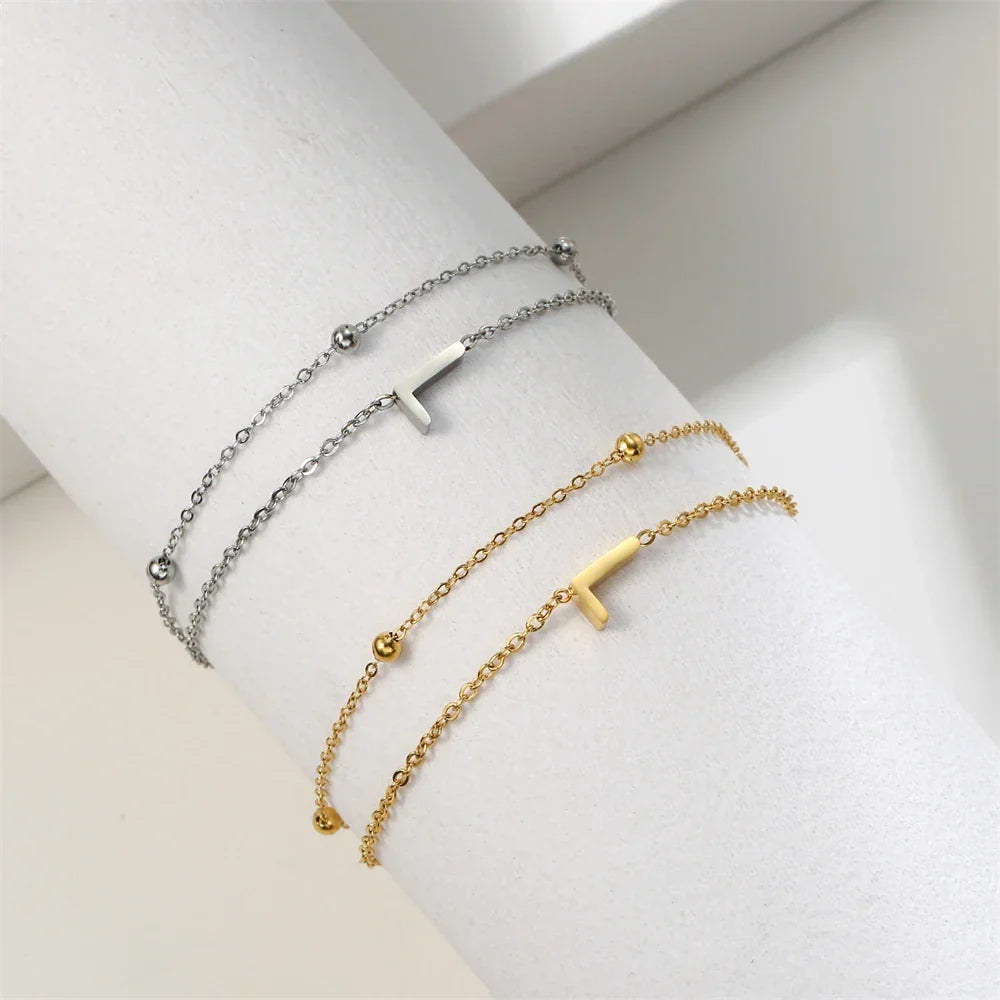Armband med dubbel initial i guld och silver l