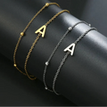 Armband med dubbel initial i guld och silver a