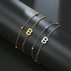 Armband med dubbel initial i guld och silver  b