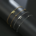 Armband med dubbel initial i guld och silver  f