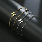 Armband med dubbel initial i guld och silver  h