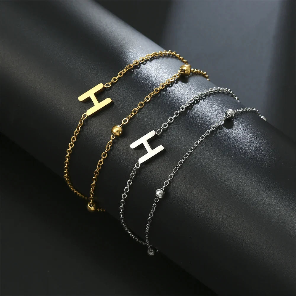 Armband med dubbel initial i guld och silver  h