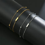 Armband med dubbel initial i guld och silver  i