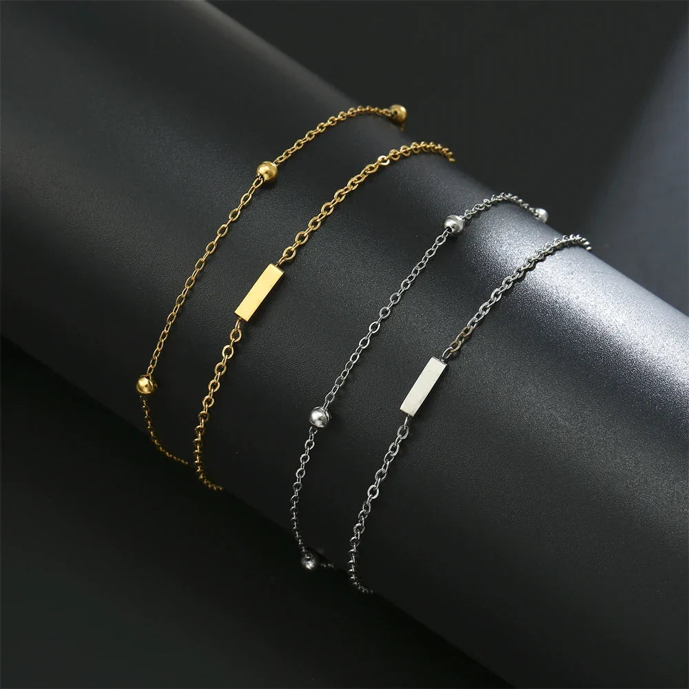 Armband med dubbel initial i guld och silver  i