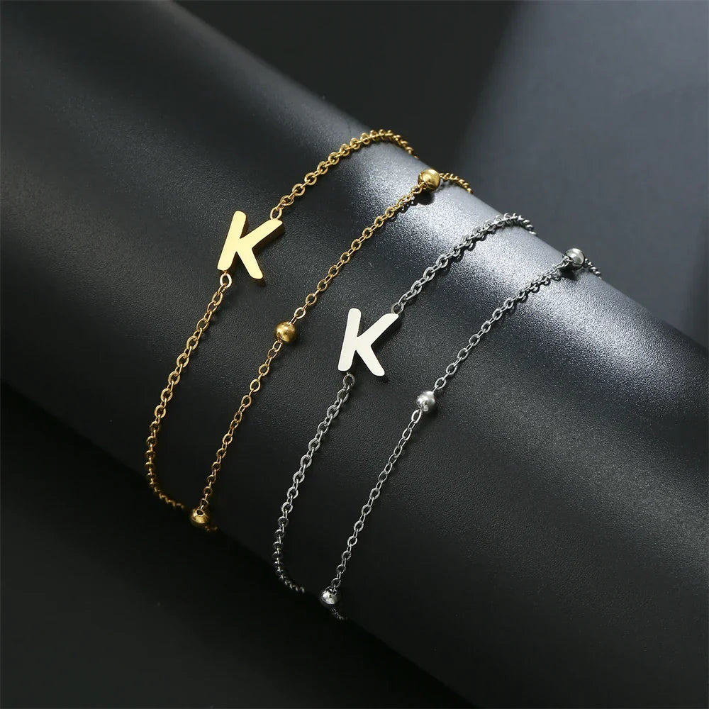 Armband med dubbel initial i guld och silver k