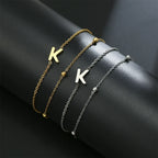 Armband med dubbel initial i guld och silver k