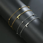Armband med dubbel initial i guld och silver  l