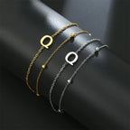 Armband med dubbel initial i guld och silver  q