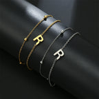 Armband med dubbel initial i guld och silver  r