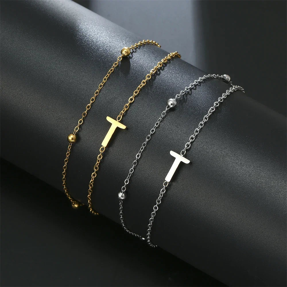 Armband med dubbel initial i guld och silver  t