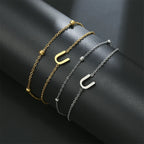 Armband med dubbel initial i guld och silver  u