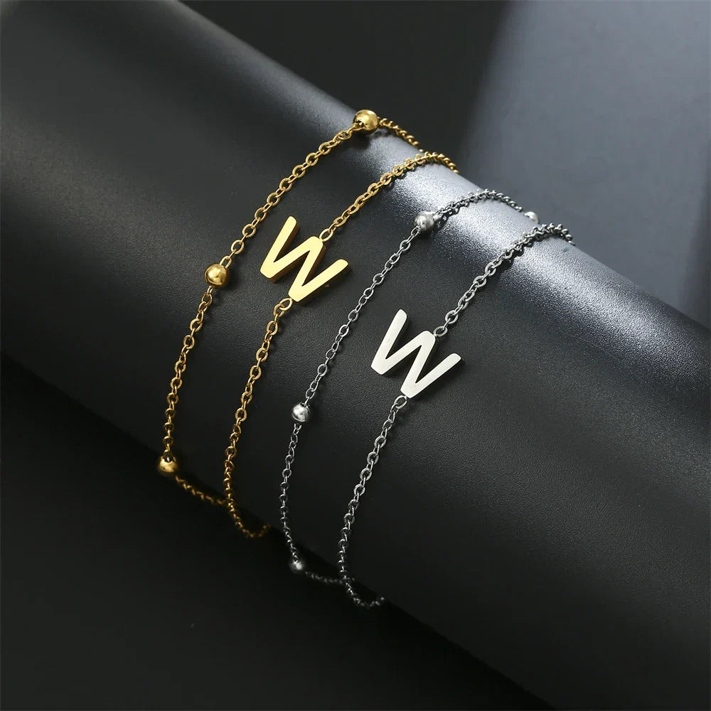 Armband med dubbel initial i guld och silver  w