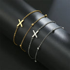 Armband med dubbel initial i guld och silver  x