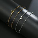 Armband med dubbel initial i guld och silver  y