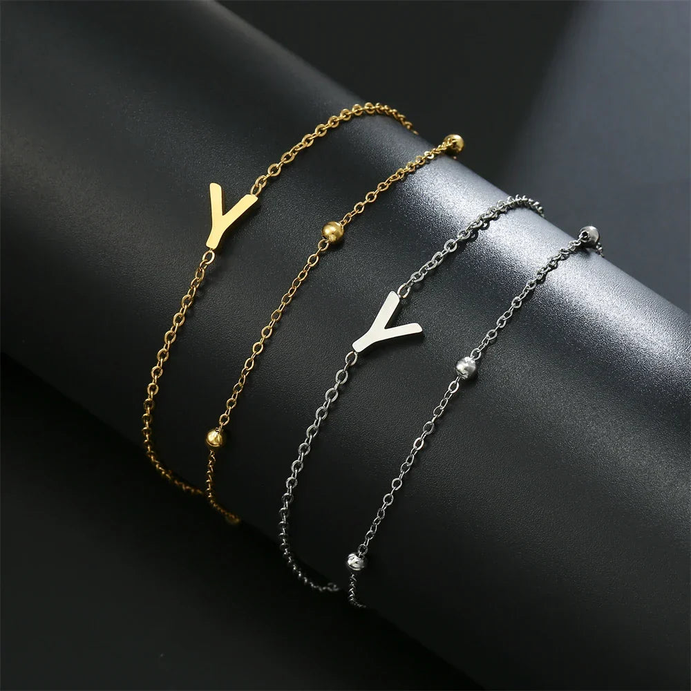 Armband med dubbel initial i guld och silver  y