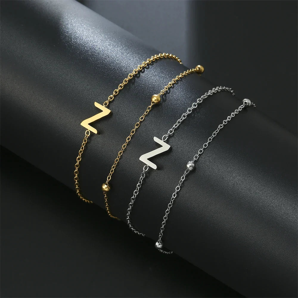 Armband med dubbel initial i guld och silver  z
