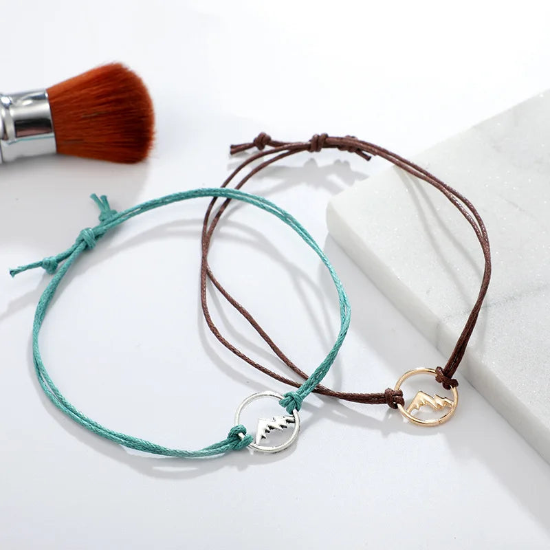 Set med 4 reparmband med rund bergsberlock