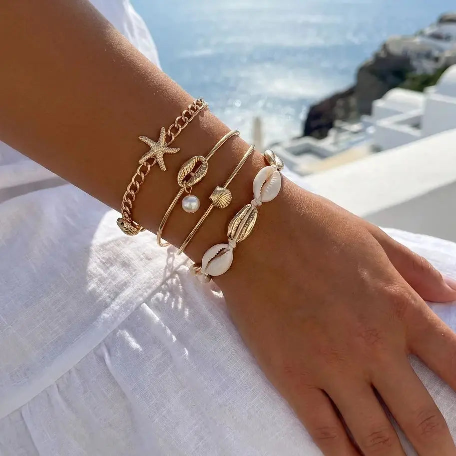 Sett med 5 gullfargede armbånd med skjell og stjerne